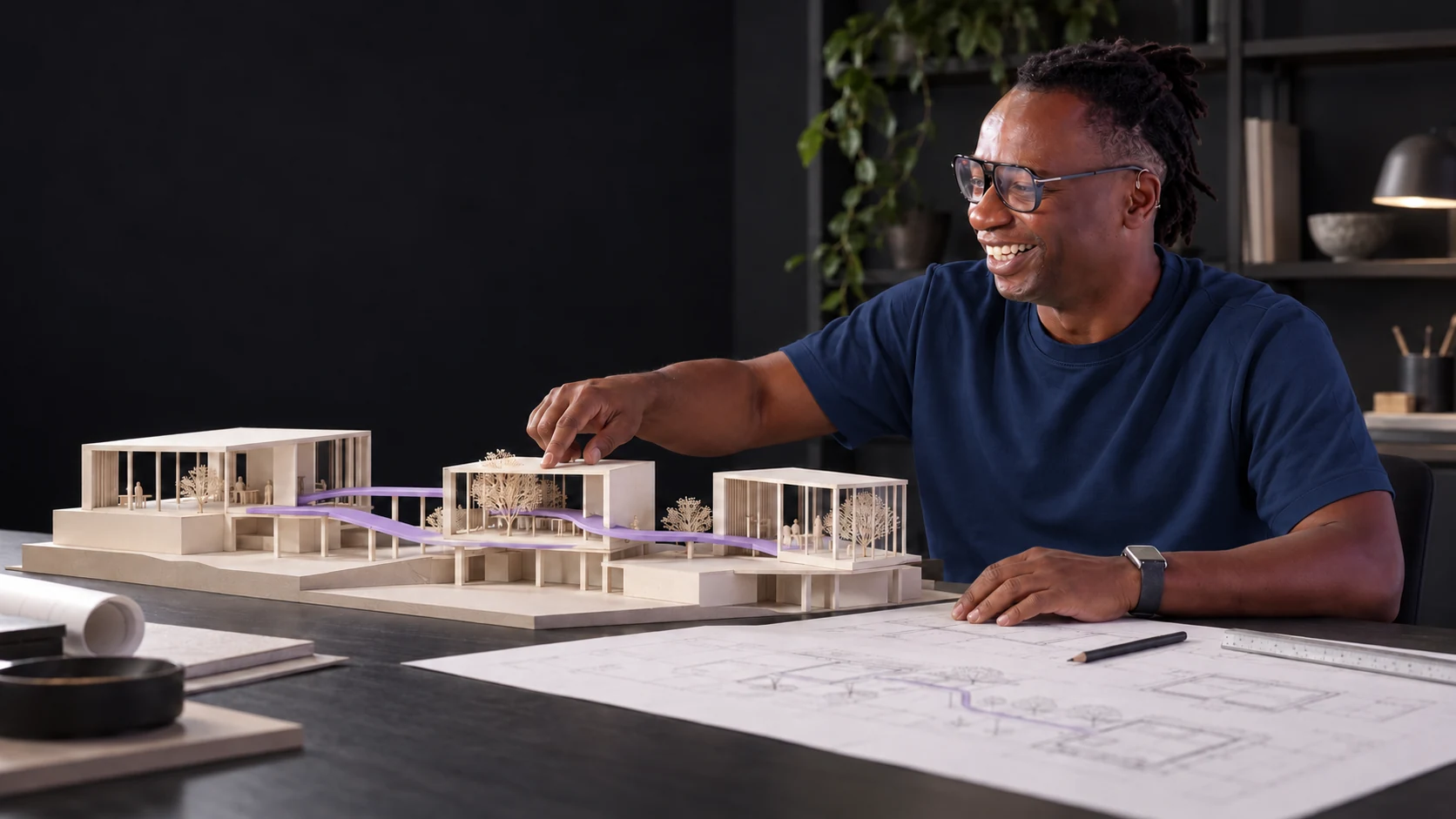 Provisional AI-generated concept portrait of Kunle Campbell in a navy T-shirt, reviewing an architectural model.